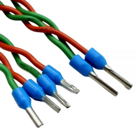 Close-up of the twisted green and orange wires with insulated ferrule terminals.