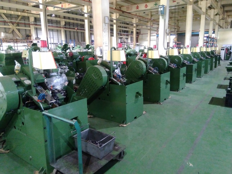 A row of newly manufactured KONFU thread rolling machines for M5 screws prepared for shipment in our factory.