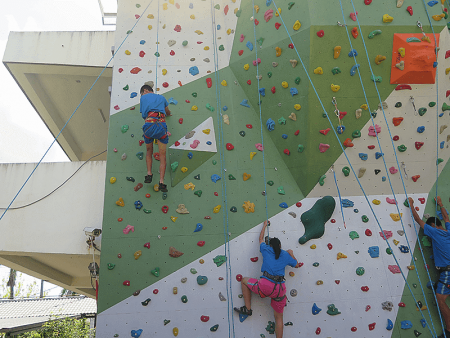 Youth participating in an indoor rock climbing activity sponsored by ChunCheng Education Development Association