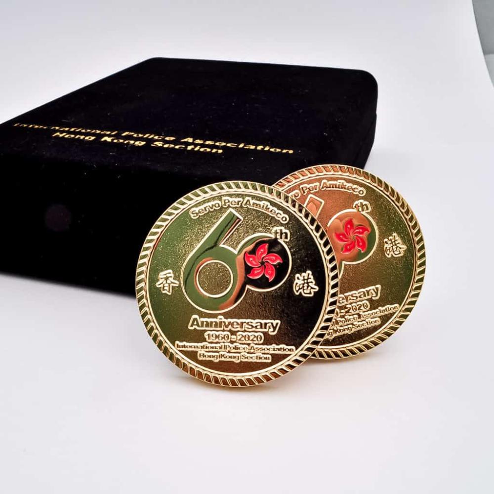 Commemorative coins for the 60th anniversary of the International Police Association Hong Kong Section, showcasing detailed craftsmanship.