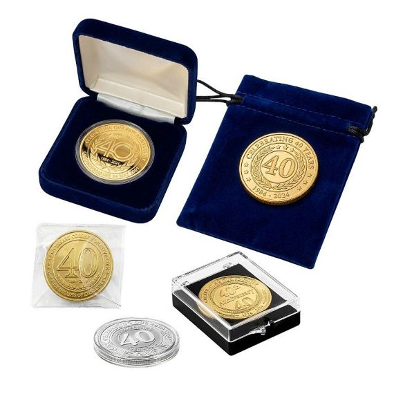 Custom metal souvenir coins displayed with multiple packaging solutions, such as velvet cases, stands, and clear acrylic boxes.