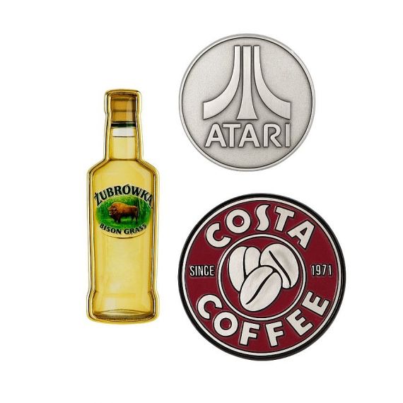 Custom branded metal pins in various shapes and finishes, showcasing distinctive logos for promotional use.