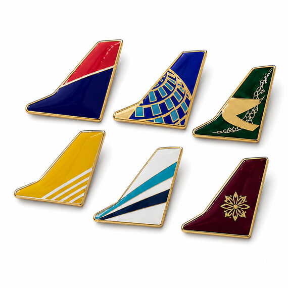 Imitation Hard Enamel airline tail-fin pins with epoxy coating in multiple custom color designs.