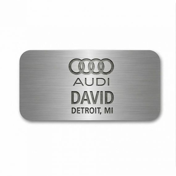 Automotive industry aluminum name badge with deep-etched black logo and employee name; professional metal ID tags for car dealerships.