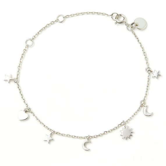 Dainty silver chain bracelet with custom tiny star, moon, and heart charms, elegant personalized celestial jewelry for everyday wear and gifting.