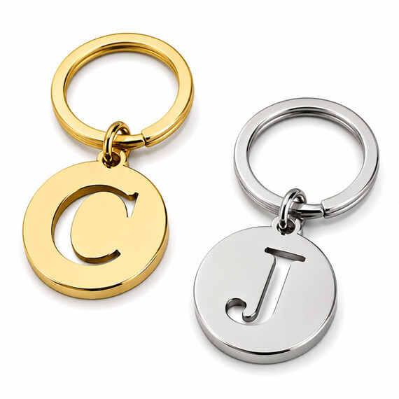 Custom cutout letter keychains in polished gold and nickel with C and J monogram designs