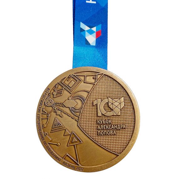 Antique bronze custom award medal with geometric 3D relief and a blue sublimated ribbon