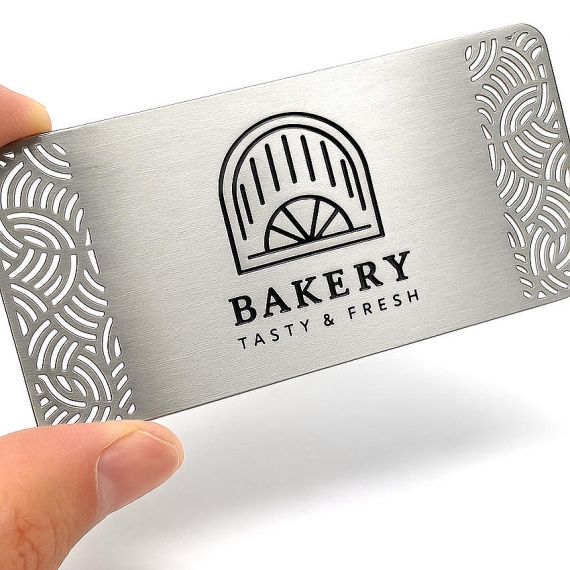 Personalized stainless steel business card with hollow out filigree design and black silk screen logo for bakery and boutique shops.