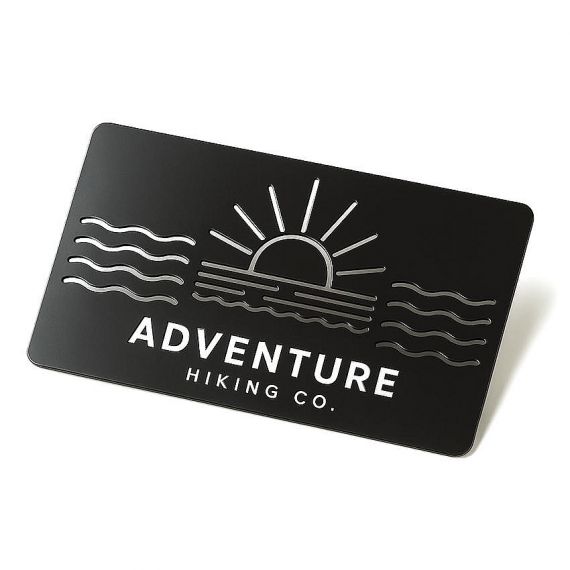 Premium matte black metal business card with laser cut wave patterns and crisp white engraved text for outdoor and hiking brands.
