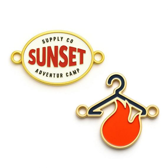 Vibrant soft enamel metal labels featuring a hanger and flame logo; custom brand identifiers for designer fashion labels, Vietnam factory direct.