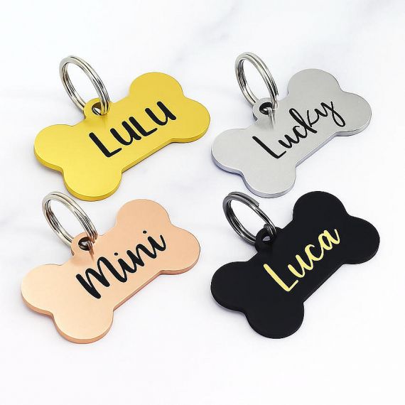 Four custom bone shaped pet ID tags with elegant cursive name engraving are manufactured by our professional metal factory in Vietnam.