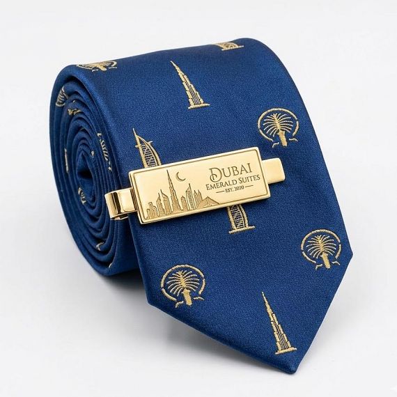 Bespoke Rectangular Gold Tie Clip Featuring Custom Dubai Emerald Suites Logo and Cityscape Etching