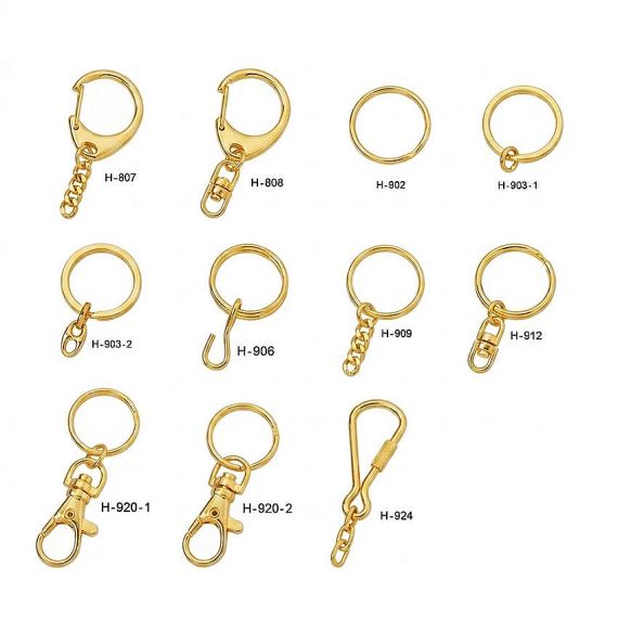 Various gold-plated metal keychain attachments including split rings, swivel snaps, and lobster clasps for custom hardware selection
