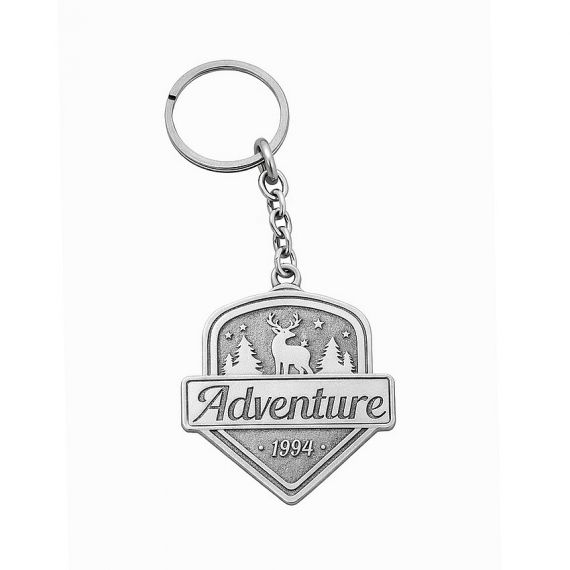 matte silver brass keychain with a recessed stamped adventure 1994 logo