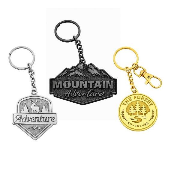 Metal stamped brass keychains with adventure and mountain-themed designs