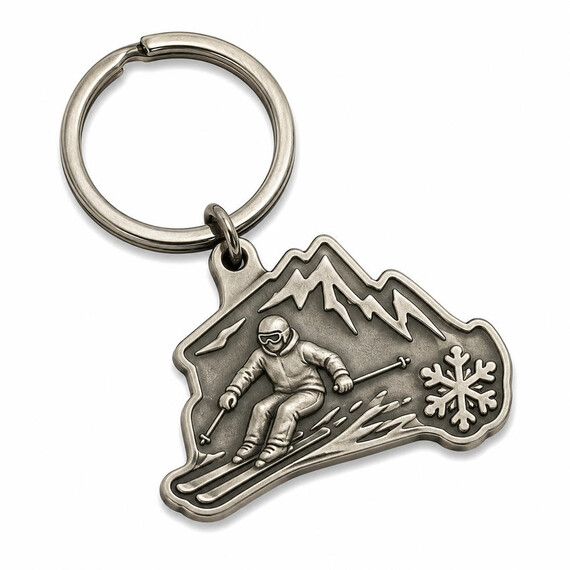 Antique silver custom metal keychain with detailed skier, mountain, and snowflake relief in a no-color zinc alloy design