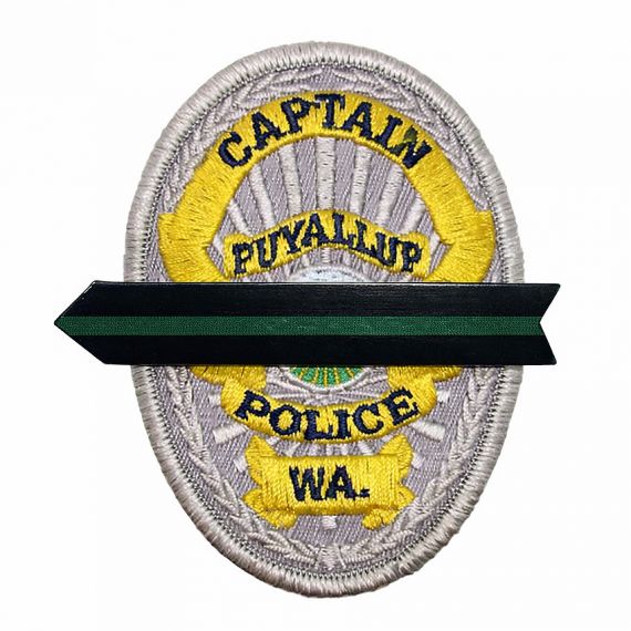 Black mourning band on embroidered police badge