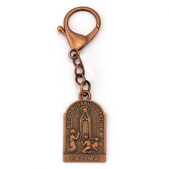 Antique copper religious keychain featuring Our Lady of Fatima relief design with detailed engraved figures
