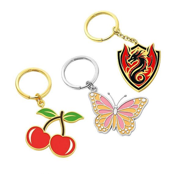 Custom brass enamel keychains featuring cherry, butterfly, and dragon designs