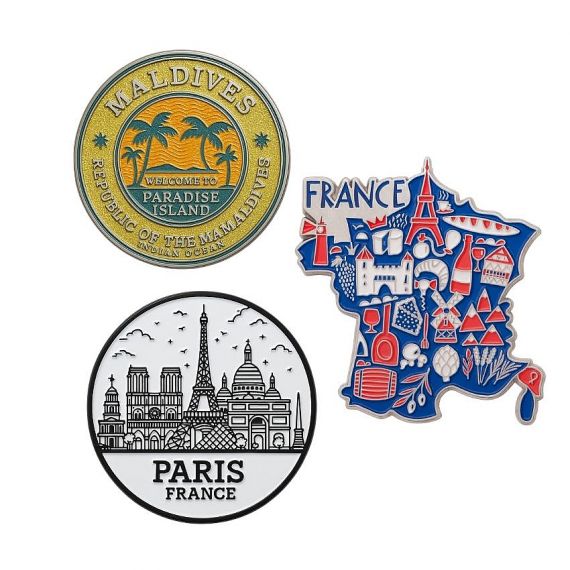 Custom made travel-themed souvenir pins featuring France, Paris, Maldives