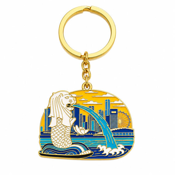 Gold-plated Singapore souvenir keychain with colorful enamel details.