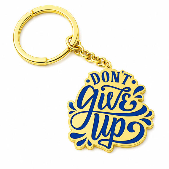Gold-plated motivational quote keychain with blue enamel lettering.