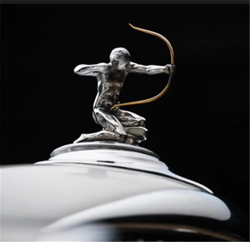 The iconic Rolls-Royce Spirit of Ecstasy hood ornament, a classic example of an auto emblem.