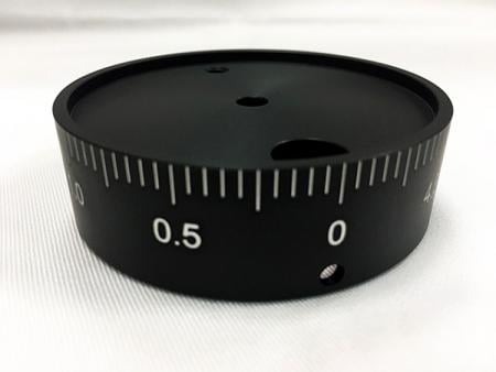 After dying black, the number is engraved for use in optical equipment.