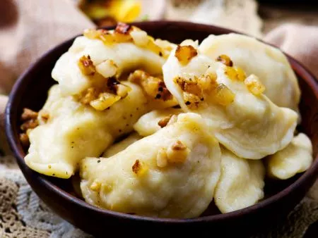 Pierogi that are filled and formed plump that look handmade