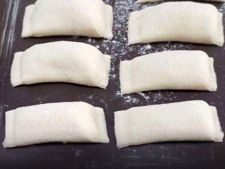 Firmly sealed Pizza Rolls with delicate pleats on the edges
