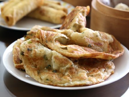 The unique pastry folding device is designed to produce Scallion Pancakes with 32 layers that are flaky and light