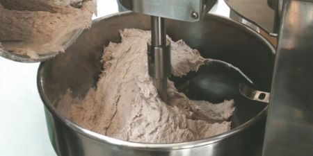 Loading fish paste or meat paste into a hopper.