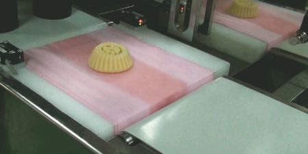 Our Automatic Stamping Machine can form and stamp unique prints on mooncakes and maamoul