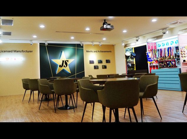Newly renovated Taipei showing with numerous metal samples, embroidery patches, and other promotional items
