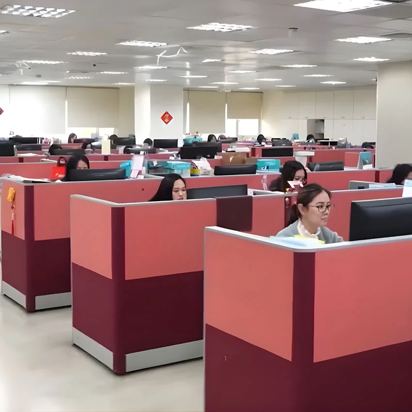Open-plan office at Jin Sheu's Taipei headquarters with employees working at partitioned desks in a modern workspace.