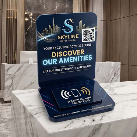 Custom dark blue acrylic NFC guest service stand displayed on a hotel reception counter.