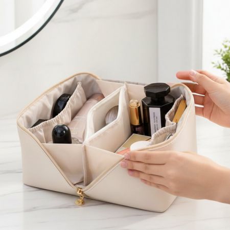 White leather vanity bag opened up showing the content inside