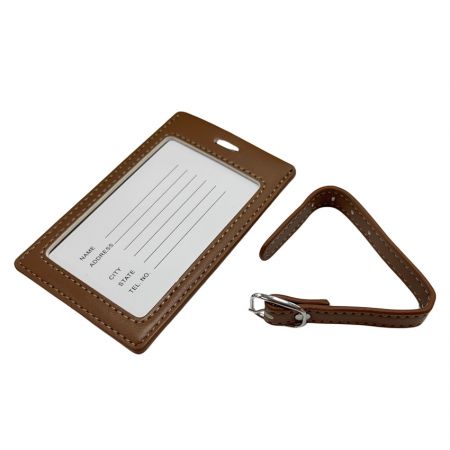 The back side of leather luggage tag with information card and an leather strap