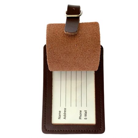 Back side of leather travel bag tag with information card revealed