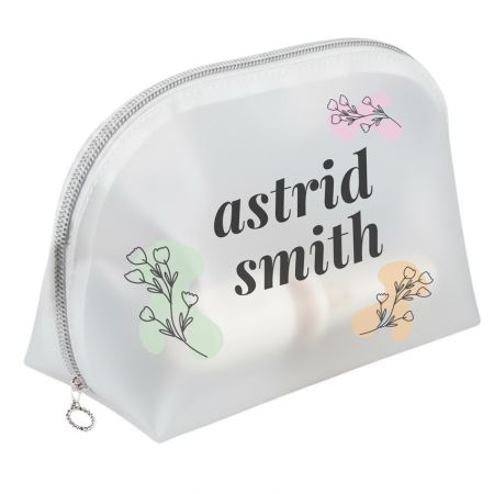 Printed makeup bag opened to display makeup brushes, perfume bottle, and eyeshadow palette inside