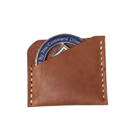 a leather coin holder with a slanted opening