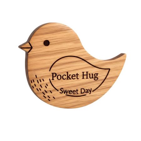 Pocket hug token with bird design symbolizing care and freedom