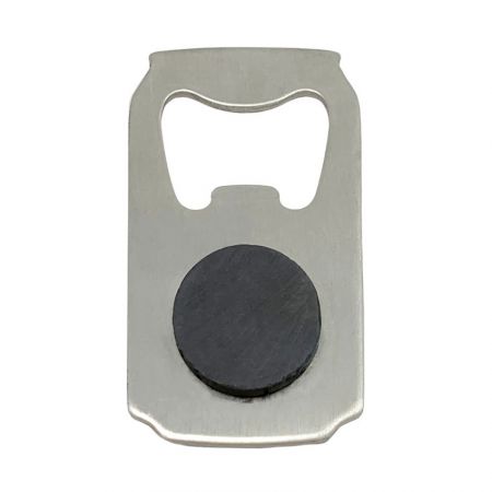 The backside of the bottle opener with a black magnet fitting.