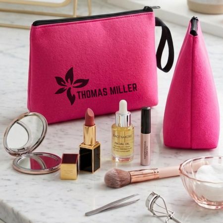 Custom printed pink neoprene cosmetic bags with logo, displayed with makeup products on marble surface