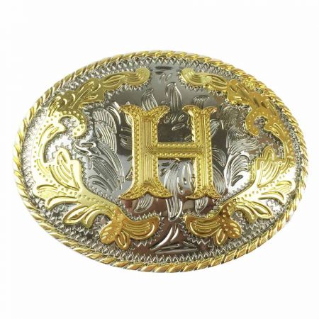 Lännen vyönsolki, jossa kultainen H hopeataustalla