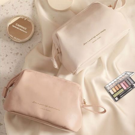 Two leather cosmetc bag, one in pink color, the other in white