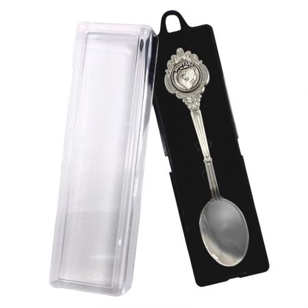 commemorative spoon in a plastic box with lid open