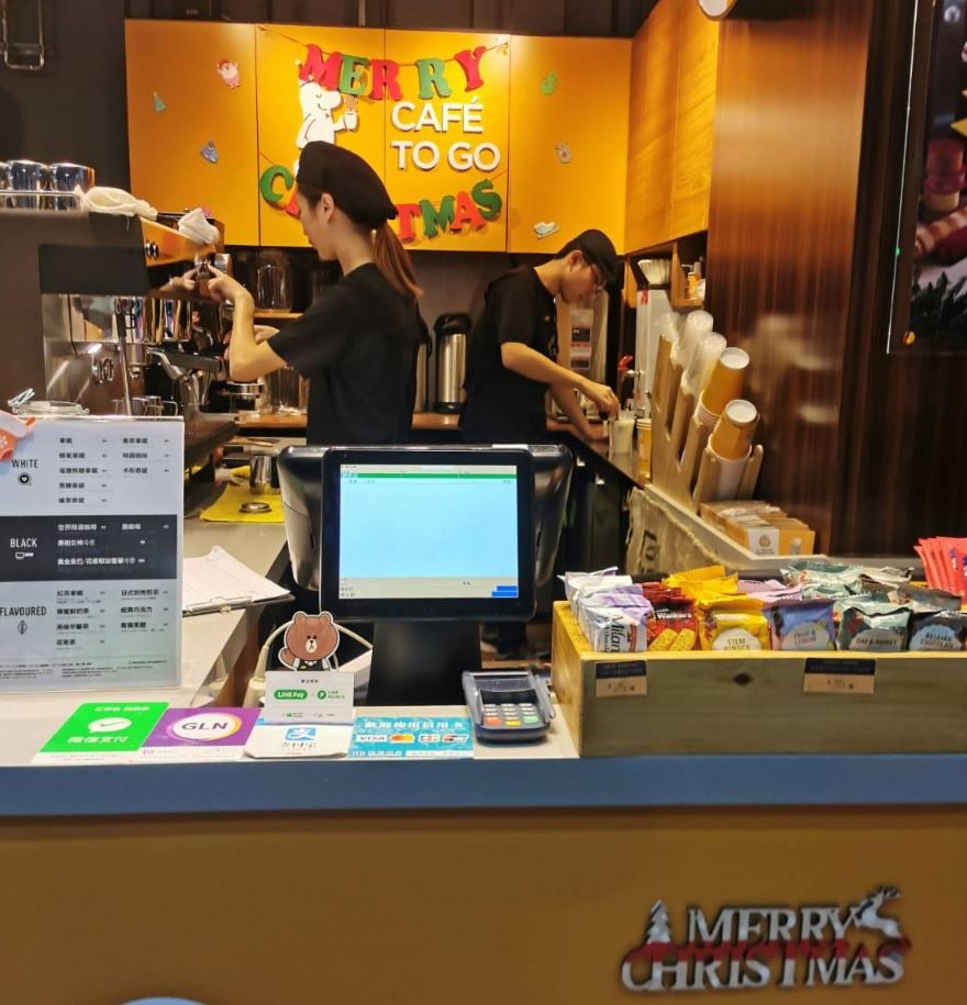 An all-in-one POS system in a bustling coffee shop for seamless order processing.