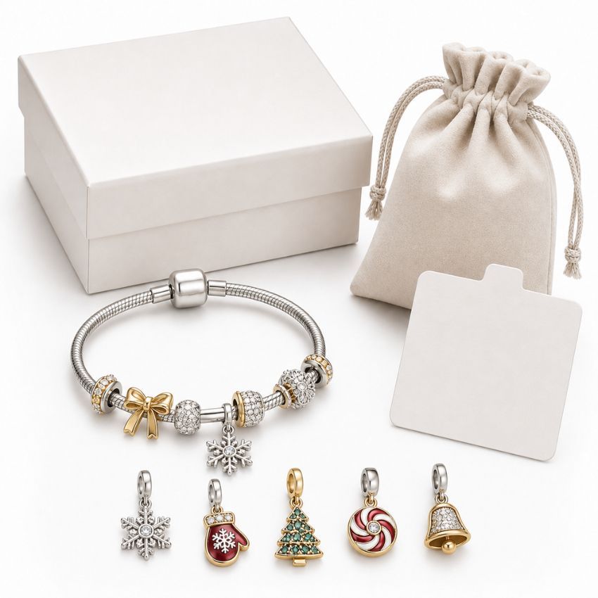 Custom Christmas charm bracelet with snowflake and mitten charms, white gift box, and pouch for wholesale packaging.