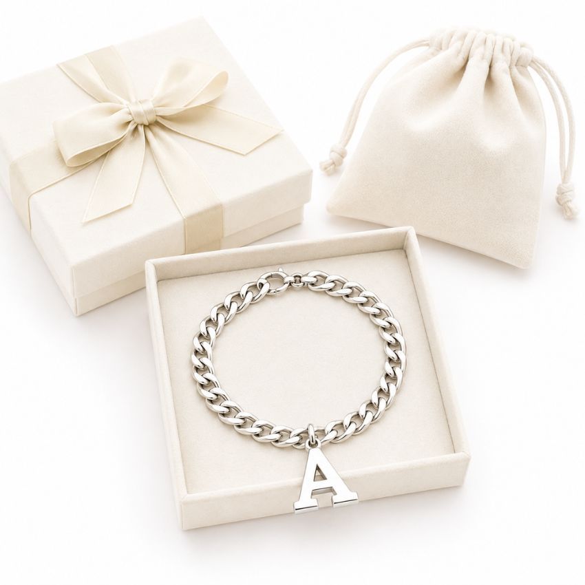 Silver curb chain bracelet with an initial A charm in a jewelry gift box, ideal for personalized jewelry wholesale.
